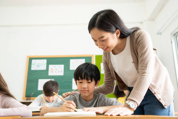 istock Asian Japanese boy writing at desk 1500641603