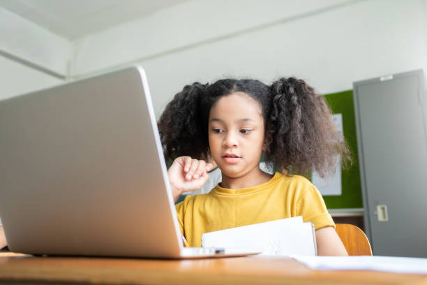 istock African American Elementary schoolgirl studying with laptop 1500641639