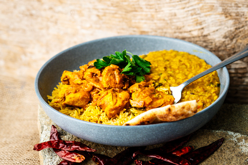A Northern Indian Chicken Curry dish with Dahl, Naan, and Basmati Rice.