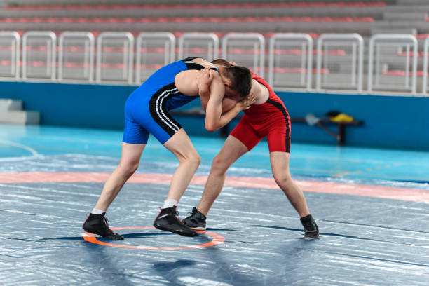 istock Hand Fighting By Two Wrestlers Trying To Gain Dominant Position During Match 1500641861