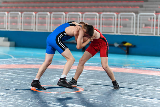 Hand Fighting By Two Wrestlers Trying To Gain Dominant Position During Match Hand Fighting By Two Wrestlers Trying To Gain Dominant Position During Match greco stock pictures, royalty-free photos & images