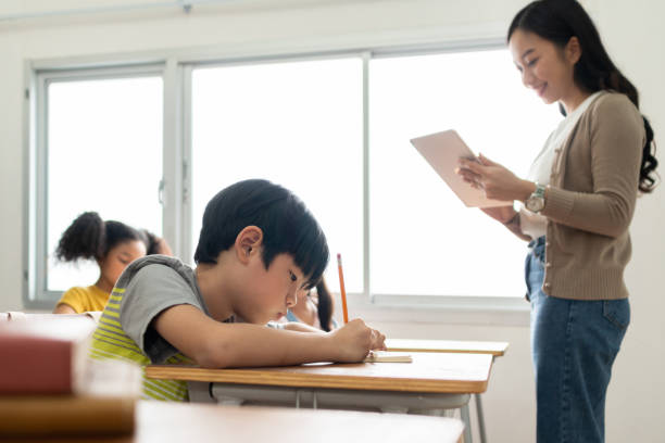 istock Asian children and teacher in classroom 1500641871