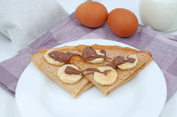 istock Pancakes with strawberries and ingredients for cooking. 1500649594