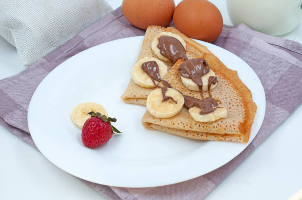 istock Pancakes with strawberries and ingredients for cooking. 1500649623