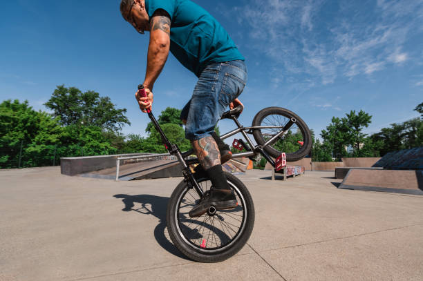 istock A middle-aged tattooed man is practicing an extreme sport in a skate park. 1500651422