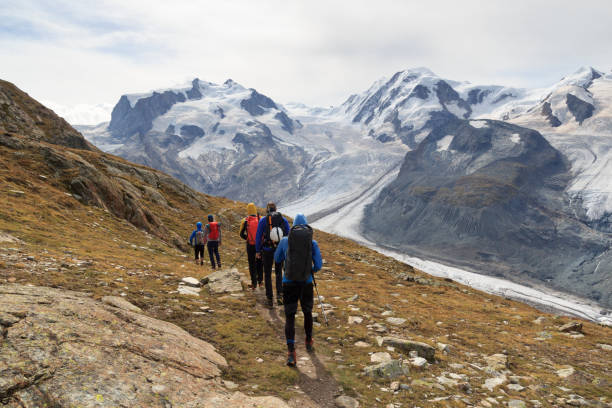 istock Panorama view with mountain Dufourspitze (left), Gorner Glacier, mountain Lyskamm (right) and group of mountaineers hiking towards mountain massif Monte Rosa in Pennine Alps, Switzerland 1500652025