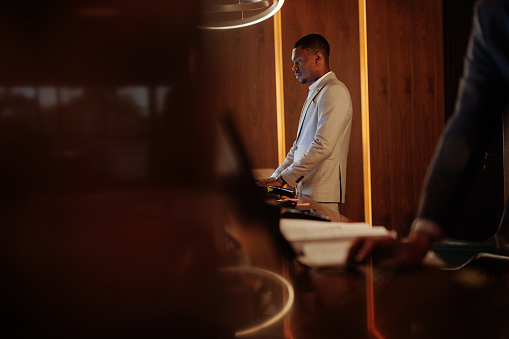 Hotel Receptionist Job Using Computer Africanamerican Hotel Receptionist Behind Helpdesk Using Computer Stock ...