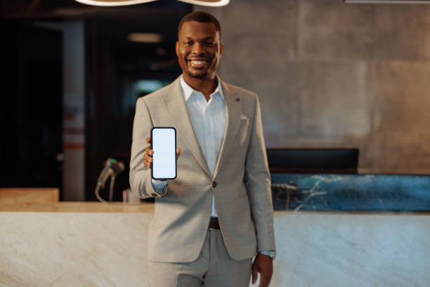istock African-American hotel receptionist holding phone 1500652876