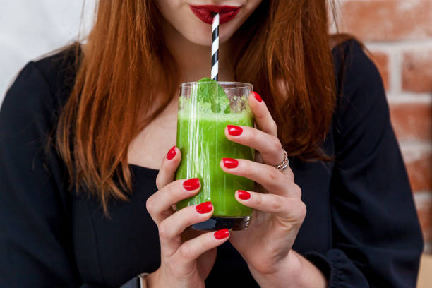 istock Girl drinking spinach, avocado and mint smoothie 1500653396