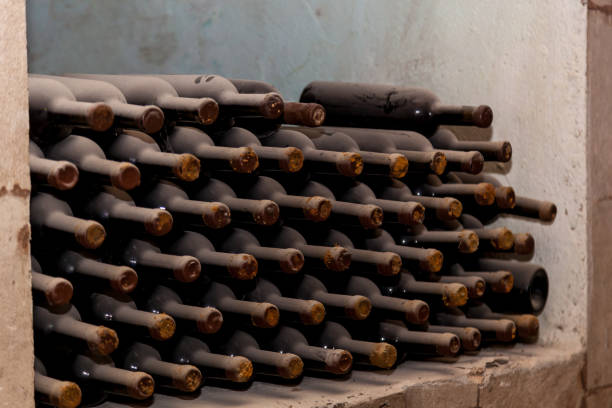 istock Old bottles of wine stacked in rows 1500653757