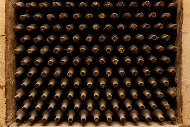 istock Old bottles of wine stacked in rows 1500653782