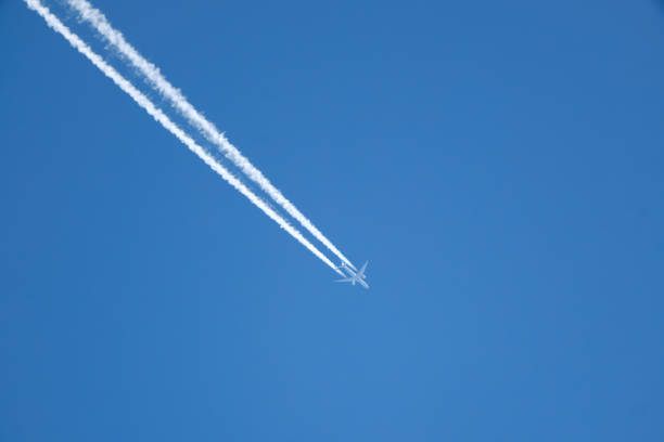 istock White contrails stream across the clear blue sky 1500653844