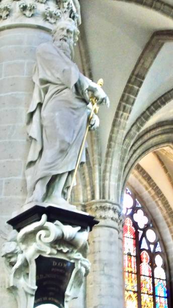 istock immortalized in a massive stone statue, st. paul clutches a golden sword while affixed to a column of the nave of the cathedral of st. michael and st. gudula in brussels, belgium. 1500656926