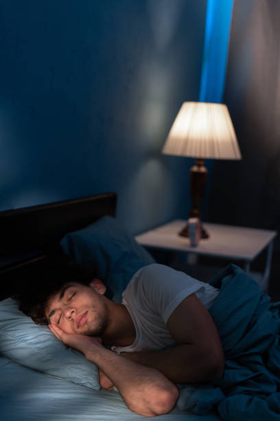 istock Good sleep concept. Handsome young man sleeping in comfortable bed alone at home, enjoying his orthopedic mattress and pillow 1500658311