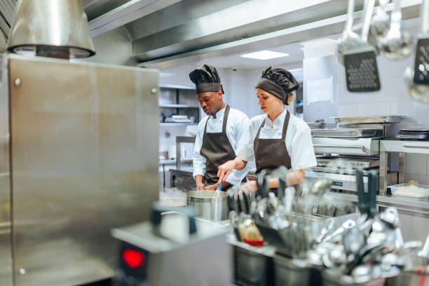 istock Multiracial team of cooks working together in kitchen 1500658451