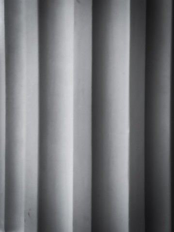 A close-up of vertical window blinds in an empty room