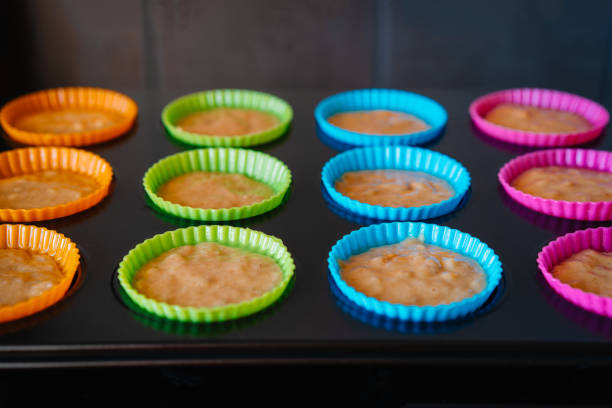 istock Muffins preparation. Raw dough in silicone tray 1500659465