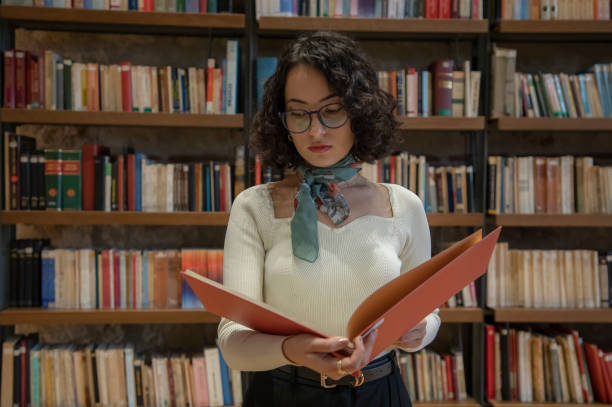 istock Young woman doing research in the library 1500663801