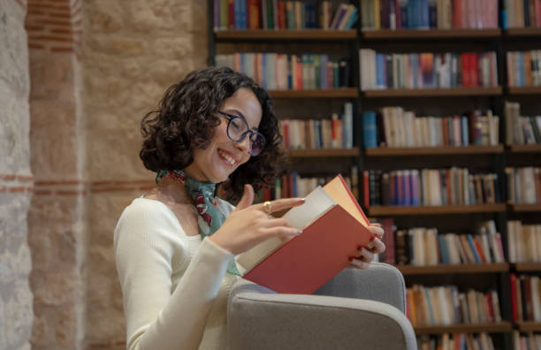 istock Young woman doing research in the library 1500663920