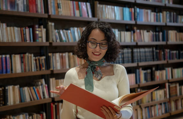 istock Young woman doing research in the library 1500663989