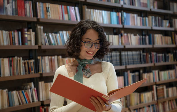 istock Young woman doing research in the library 1500664130