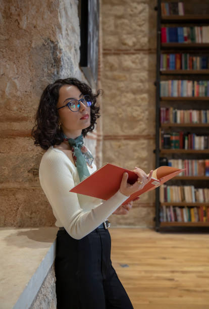 istock Young woman doing research in the library 1500664845