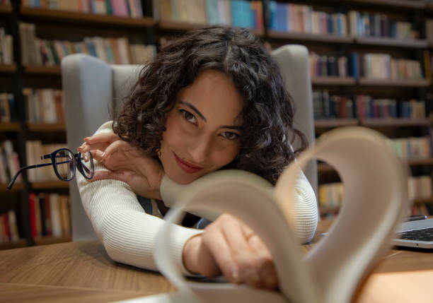 istock Young beautiful woman in the library 1500666219