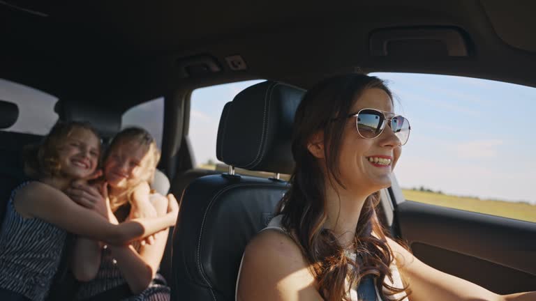 SLO MO Road Trip Bliss: Smiling Mother, Cheerful Daughters. Unforgettable Family Moments.