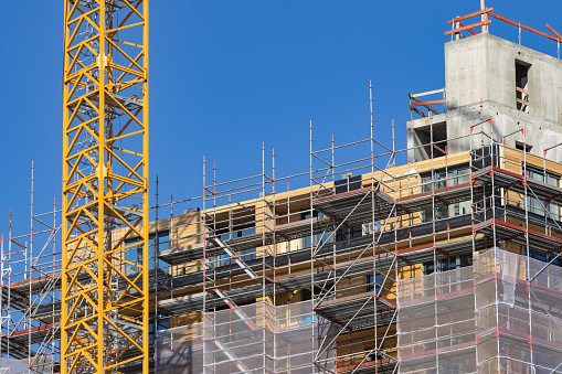 construction site of a wooden high-rise building with a crane