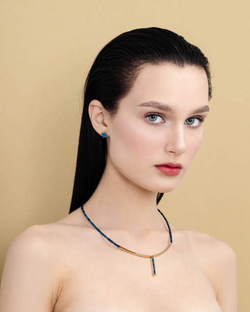 istock woman with bare shoulders posing sensually holding head up 1500672402
