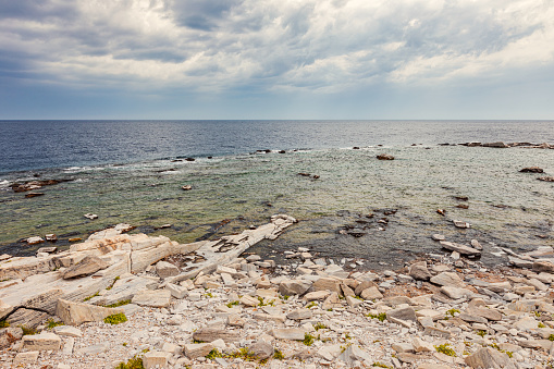 a picture of a Rocky coastline near the ocean in Maine United States