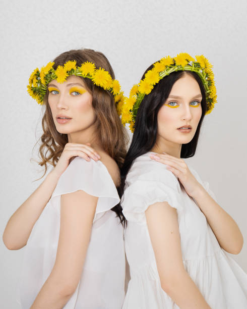 istock two Young girls with wreaths from dandelions 1500677232