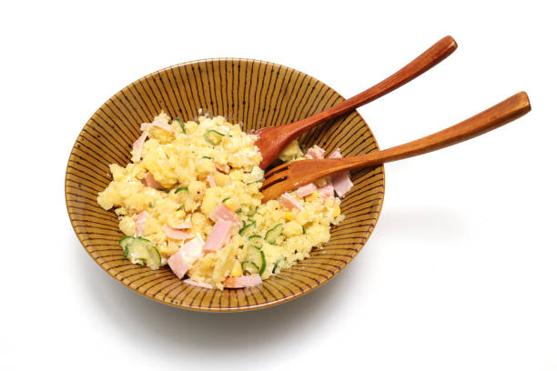 Potato salad in a bowl isolated on a white background.