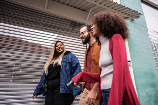 istock Friends talking while walking in the street 1500679743