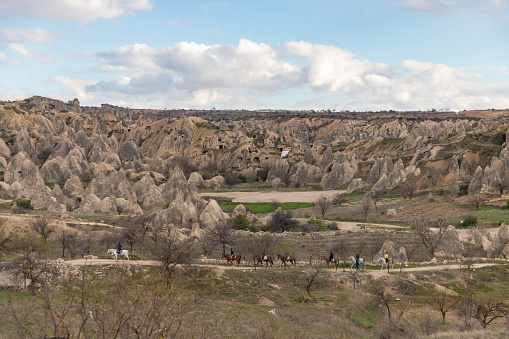 A picture of a horse tour happening on the Goreme Historical National Park, taken near the Sword Valley.