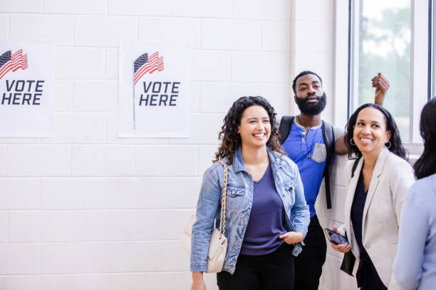 istock Diverse voters smile and laugh together while waiting in line 1500680777