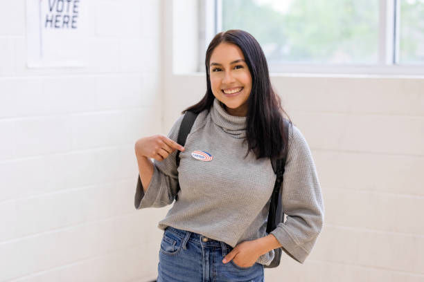 istock Happy young woman proudly points to 