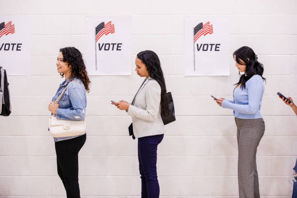 istock Profile view diverse women standing in line to vote 1500680800
