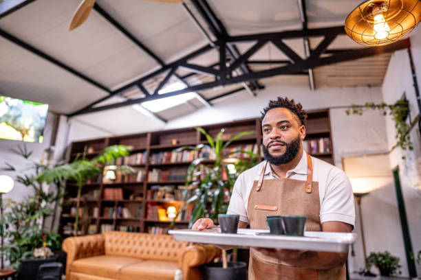 istock Waiter carrying a serving tray with coffee in a cafe 1500680893