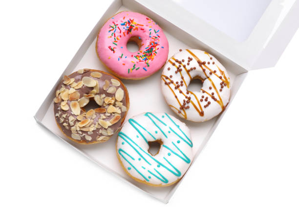 istock Box with tasty glazed donuts isolated on white, top view 1500681027