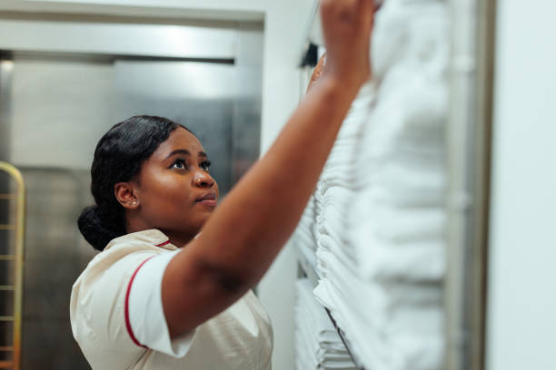 istock African-American uniformed hotel maid working in laundry 1500682399