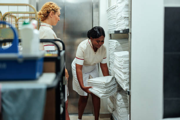 istock Two diverse hotel maids cooperating in laundry 1500683717