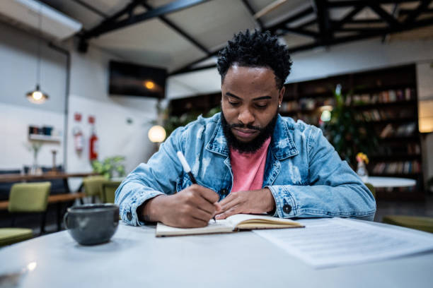 istock Mid adult man studying in a coffee shop 1500685050