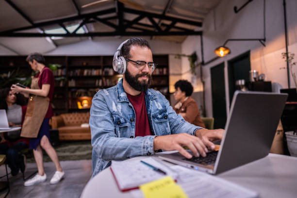 istock Mid adult man using the laptop in a cafe 1500685143