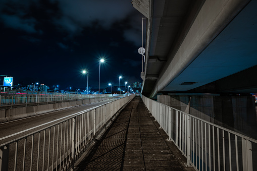 Sidewalk on a bridge at night