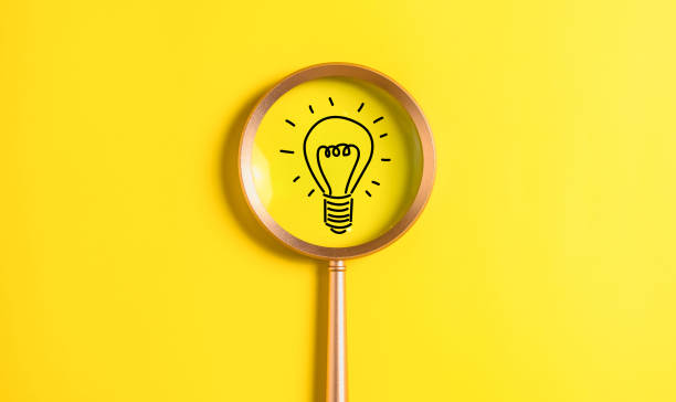 istock idea light bulb icon on magnifying glass. idea and new design concept on clean background. 1500687594