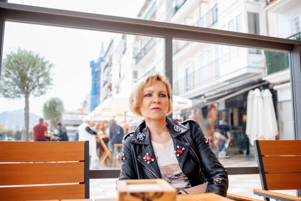 istock Mature woman in a sidewalk cafe 1500687694