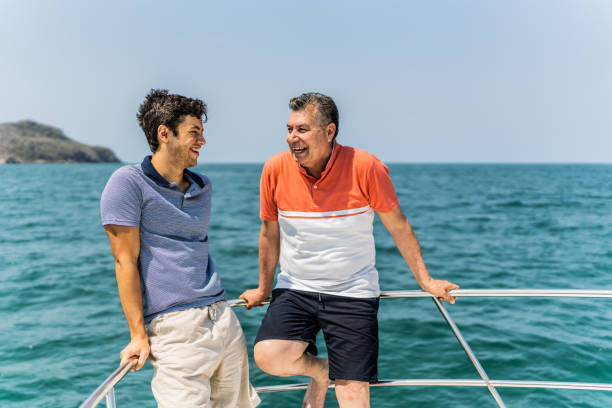 istock Father and son talking on boat deck during a yacht trip 1500687740