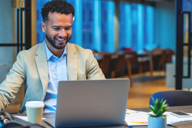 istock Business man working at the office working. He is working on laptop and has paperwork around him with finance data 1500692214