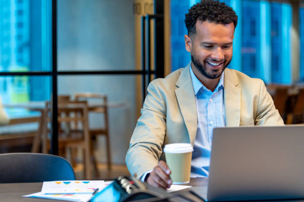 istock Business man working at the office working. He is working on laptop and has paperwork around him with finance data 1500692238